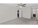 Bright bedroom with carpet, ceiling fan and access to bathroom at 608 Pleasant Ave, Kannapolis, NC 28081