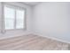 Bright bedroom with light wood floors and window coverings at 6134 Anglin Pl, Mint Hill, NC 28227