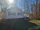 Newly renovated ranch home with gray siding, red accents, and landscaped yard at 7154 Woodcock Trl, Stanley, NC 28164