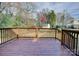 Wooden deck overlooks backyard with mature trees at 8607 Larchmont Cir, Charlotte, NC 28214