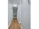 Bright hallway with hardwood floors and neutral walls, leading to bedrooms at 8607 Larchmont Cir, Charlotte, NC 28214