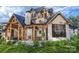 Back exterior showcasing screened porch and stone fireplace at 0 S Potter Rd # 2B, Waxhaw, NC 28173