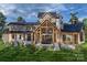 Home's back exterior with large covered patio and stone accents at 0 S Potter Rd # 2B, Waxhaw, NC 28173