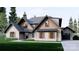 Two-story craftsman style home with stone and wood siding, attached garage, and landscaped lawn at 156A Lookout Dam Rd, Statesville, NC 28625