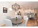 Bright dining room featuring a round table, four chairs, and an elegant chandelier at 2353 Abundance Ln, Waxhaw, NC 28173