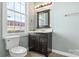 Clean bathroom with dark vanity, single sink, and a window for natural light at 301 Wilson N St, Rock Hill, SC 29730