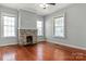 Living room featuring hardwood floors and a stone fireplace at 301 Wilson N St, Rock Hill, SC 29730