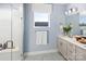 Modern bathroom with double vanity, large shower, and light blue walls at 3037 Finchborough Ct # 222, Charlotte, NC 28269