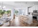 Open concept kitchen with white cabinets, island, and breakfast area at 3037 Finchborough Ct # 222, Charlotte, NC 28269