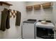 Laundry room with washer, dryer, and shelving for storage at 3037 Finchborough Ct # 222, Charlotte, NC 28269