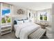 Bright main bedroom with plush bed, sitting area, and large windows at 3037 Finchborough Ct # 222, Charlotte, NC 28269