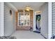 Inviting front porch with brick and siding detail, ceiling fan, and entry door at 312 Garnet Ct, Fort Mill, SC 29708