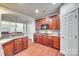 Kitchen boasts dark wood cabinets, granite counters, and an open layout at 312 Garnet Ct, Fort Mill, SC 29708