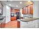 Kitchen features dark wood cabinetry, granite countertops, and black appliances at 312 Garnet Ct, Fort Mill, SC 29708