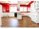Kitchen with white cabinets, island, and red walls at 505 Liledoun Rd, Taylorsville, NC 28681