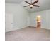 Main bedroom with ceiling fan and access to en-suite bathroom at 10319 Dominion Village Dr, Charlotte, NC 28269