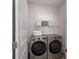 Laundry room with washer and dryer and additional shelving at 111 Newbold Ln, Mooresville, NC 28115