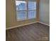 Bright bedroom with large windows and wood-look flooring at 1174 Plaza Walk Dr, Charlotte, NC 28215