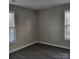 Spacious bedroom with two windows and grey flooring at 1174 Plaza Walk Dr, Charlotte, NC 28215