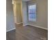 Bedroom with window and door to hallway at 1174 Plaza Walk Dr, Charlotte, NC 28215
