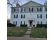 Three-story building exterior with landscaping and walkway at 1174 Plaza Walk Dr, Charlotte, NC 28215