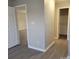 Spacious hallway with light gray walls and wood-look flooring at 1174 Plaza Walk Dr, Charlotte, NC 28215