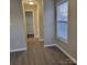 Hallway with a closet and wood-look flooring at 1174 Plaza Walk Dr, Charlotte, NC 28215
