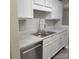 White kitchen cabinets, granite counters, and double sink at 1174 Plaza Walk Dr, Charlotte, NC 28215