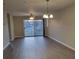 Bright living room with hardwood floors, ceiling fan, and chandelier at 1174 Plaza Walk Dr, Charlotte, NC 28215