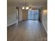 Spacious living room with sliding glass door and hardwood floors at 1174 Plaza Walk Dr, Charlotte, NC 28215