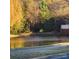Peaceful pond with a wooden bench and scenic surroundings at 1174 Plaza Walk Dr, Charlotte, NC 28215