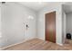 Front entry with light gray walls, wood-look flooring, and a coat closet at 2000 Lilly Pond Ct, Charlotte, NC 28273