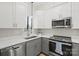 Modern kitchen with stainless steel appliances and gray cabinets at 224 N Poplar St # 16, Charlotte, NC 28202