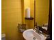 Simple bathroom with a sink, toilet, and yellow walls at 306 Mcadenville Rd, Lowell, NC 28098