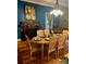 Dining room with hardwood floors, chandelier, and peacock art at 306 Mcadenville Rd, Lowell, NC 28098
