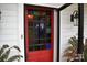 Red front door with stained glass window and ornate brass doorknob at 306 Mcadenville Rd, Lowell, NC 28098
