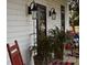 Front porch with red rocking chairs, potted plants, and elegant light fixtures at 306 Mcadenville Rd, Lowell, NC 28098