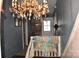 Hallway with gray walls, a chandelier, and a quilt at 306 Mcadenville Rd, Lowell, NC 28098