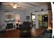 Living room with hardwood floors, fireplace, and view into kitchen at 306 Mcadenville Rd, Lowell, NC 28098