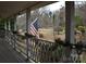 Relaxing porch with flag and greenery at 306 Mcadenville Rd, Lowell, NC 28098
