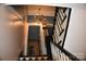 View of a staircase with black railings and a chandelier at 306 Mcadenville Rd, Lowell, NC 28098