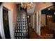 Black and white checkered staircase with crystal chandelier at 306 Mcadenville Rd, Lowell, NC 28098