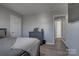 Spacious bedroom with gray walls, wood-look floors, and ample closet space at 4805 Stowe Derby Dr, Charlotte, NC 28278