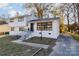 Newly renovated two-story house with white exterior and manicured lawn at 6521 Heatherbrook Ave, Charlotte, NC 28213