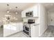 Modern kitchen boasting stainless steel appliances and white cabinets at 6521 Heatherbrook Ave, Charlotte, NC 28213