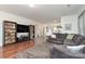 Living room with hardwood floors, built-in shelving, and large TV at 7126 Sonja Dr, Clover, SC 29710