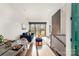 Bright living room features a navy sofa, dining area, and sliding glass doors leading to a deck at 819 E 36Th St, Charlotte, NC 28205