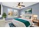 Virtually staged bedroom with blue-gray walls, ceiling fan, and hardwood floors at 8217 Curico Ln, Charlotte, NC 28227