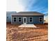 Rear view of house with gray siding and patio at 1058 Bull Dog Ln, Wingate, NC 28174