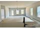Spacious living room with large windows and hardwood floors at 1058 Bull Dog Ln, Wingate, NC 28174